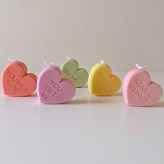 four heart shaped candys with the words you're mine written on them in different colors