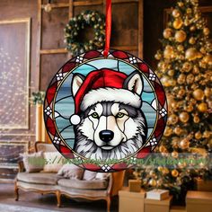 a stained glass ornament with a wolf wearing a santa hat in front of a christmas tree