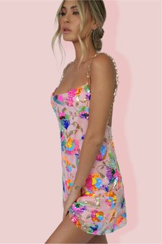 The Celebration Time Sequin Backless Mini Dress is the only reason you'll need to start the celebration! Crafted from embellished mesh overlay with delicate embroidered fluorescent and pastel flowers & sequins together with 100% poly lining. This gorgeous mini has a relaxed oversized fit throughout with a cowl neckline & plunging back. The stunning gold strap detailing attach near the bust with a super low back. Featuring a super cute flowy hem to create a flirty feel to this slip -making it a p Selena Dresses, Multicolor Sequins, Two Piece Jumpsuit, Backless Mini Dress, Cowl Neckline, Shades Of White, Flowy Skirt, Pastel Rainbow, White Mini Dress