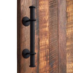 a door handle on the side of a wooden door with black handles and knobs