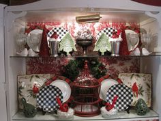 a china cabinet filled with dishes and christmas decorations