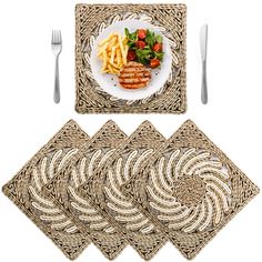 four placemats with forks and knife on top of them, next to a plate of food