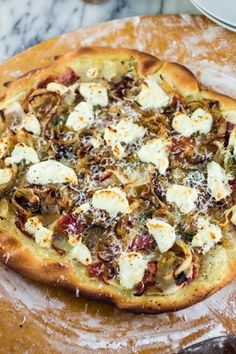 a pizza sitting on top of a wooden cutting board