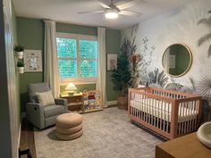 a baby's room decorated in green and white