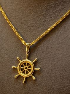 "14k Gold wheel ship pendant , weight 1.15gr , on 18k Gold Franco chain 19.5\" , 1.5mm ,2.40gr  Priced to sell! Compare our prices to other similar sellers! Arrives in a GIFT BOX and includes FREE SHIPPING within the USA and Canada. International shipping is available at the most economical rates on ETSY. I HAVE BEEN IN THE JEWELRY BUSINESS ALL MY LIFE. I am a second -generation family member making gold and jewelry. Please feel free to ask me any questions - Always happy to help! Fast Replies t Anchor Theme, Fast Replies, Navy Necklace, Necklace For Him, Boat Wheel, Gold Wheels, Anchor Necklace, Ship Wheel, Jewelry Business