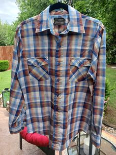 This is a Vintage 70's Sears Long Sleeve Plaid Shirt Sz 14.5. This handsome vintage shirt is a rare find and is made 65 % polyester and 35% cotton and features a straight collar, shoulders, a curved hem and double button chest pockets. It has been gently worn and is in excellent condition. Measurements Length 30" Shoulders 18.5" Chest 42" Sleeve 25" Vintage Plaid Cotton Tops, Fitted Long Sleeve Camp Shirt Casual, Fitted Long Sleeve Casual Camp Shirt, Western Style Collared Cotton Shirt, Western Cotton Collared Shirt, Western Style Cotton Collared Shirt, Vintage Cotton Shirt For Fall, Vintage Relaxed Fit Flannel Shirt With Button Closure, Vintage Long Sleeve Relaxed Fit Flannel Shirt