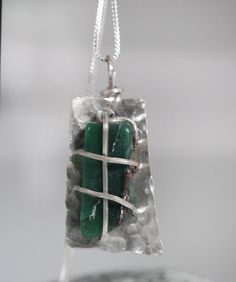 "This wonderful green agate is tied to a hammered silver piece that slightly wraps the stone. Approximately 1.5\" by 3\\/4\" at longest and widest points. 24\" silver chain included." Hand Wrapped Green Sterling Silver Jewelry, Artisan Silver Jade Necklace, Artisan Silver Necklace With Jade, Silver Wire Wrapped Moss Agate Necklace, Artisan Silver Jade Jewelry, Green Hammered Sterling Silver Jewelry, Green Sterling Silver Hammered Jewelry, Silver Rectangular Wire Wrapped Jewelry, Silver Wire Wrapped Jewelry