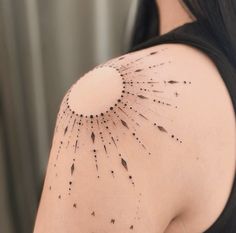 the back of a woman's shoulder with arrows and stars drawn on her arm