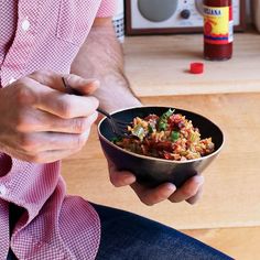 a man holding a bowl of food in his hand