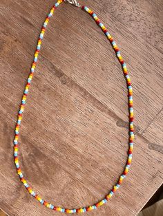 Handmade rainbow color beaded necklace. Comes with lobster clasp closure & measures at 8" long! Adjustable Multicolor Single Strand Beaded Necklace, Rainbow Round Beaded Necklaces With Tiny Beads, Multicolor Bohemian Beaded Necklace, Rainbow Single Strand Beaded Necklaces With Round Beads, Rainbow Heishi Beads For Festival, Rainbow Beaded Necklace For Festivals, Rainbow Beaded Necklace For Festival, Adjustable Rainbow Beaded Necklace With Beaded Chain, Rainbow Heishi Bead Necklace For Festivals