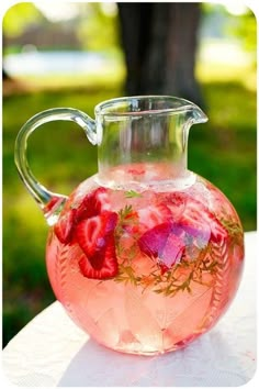 a pitcher filled with liquid sitting on top of a table