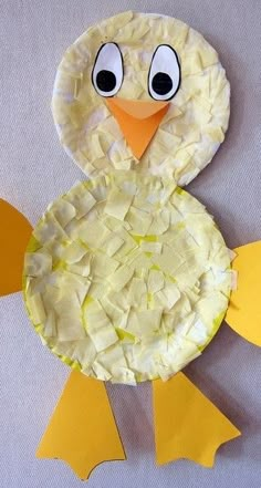 a paper plate chicken made to look like it is sitting on the table