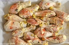 some chicken is sitting on a white plate and ready to be cooked in the oven