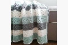 a crocheted blanket sitting on top of a couch