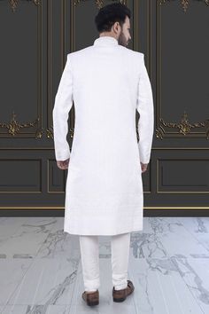 Expertly crafted, the Men's Sherwani in white presents a refined and sophisticated look. With delicate stone and thread embroidery, this Sherwani elevates your style for special occasions. Make a statement with this elegant and timeless piece. Classic Fitted Traditional Wear For Eid, Formal White Nehru Jacket With Straight Kurta Shape, Elegant White Nehru Jacket Straight Kurta, Elegant White Bandhgala Straight Kurta, Classic Formal Traditional Wear For Eid, Classic Fitted Kurta For Festive Occasions, Classic Fitted Traditional Wear For Ceremonies, White Nehru Jacket With Naqshi Detailing, Classic Formal Sherwani For Eid