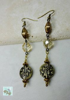 Handmade long Boho fun dangle earrings in lovely champagne, gold and bronze colors.  Great casual earrings featuring antique brass plated coin bead with an embossed floral design. A variety of Czech beads are used  including  champagne gold faceted rounds, roundels with a soft pearlized gold finish, and oval beads with a metallic bronze gleam.  The focal puffed coin beads are enhanced with brass beads and metallic bronze finish bead caps.   The earrings are about 3.25 inches long from to of the Nickel-free Gold Metal Crystal Earrings, Vintage Nickel-free Drop Beaded Earrings, Nickel-free Vintage Drop Beaded Earrings, Vintage Bronze Round Bead Earrings, Vintage Bronze Earrings With Round Beads, Gold Bohemian Crystal Earrings, Vintage Beaded Dangle Earrings, Antique Gold Copper Drop Earrings, Bohemian Gold Crystal Earrings In Brass