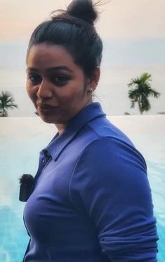 a woman standing in front of a swimming pool