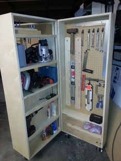 a tool cabinet with tools in it is open and ready to be used as a workbench