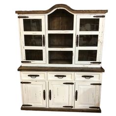 an old white hutch with glass doors and drawers on it's sideboard