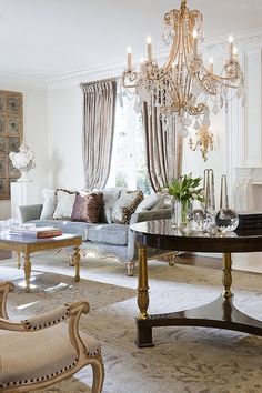 a living room filled with furniture and a chandelier