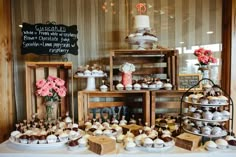 a table topped with lots of cupcakes and cakes