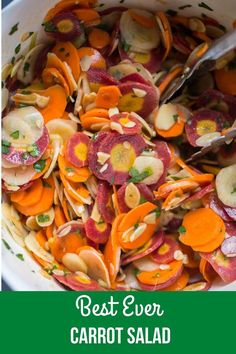 a white bowl filled with lots of different types of veggies next to a spoon