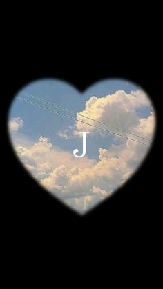 a heart shaped photo with the letter j in it's center and clouds behind it