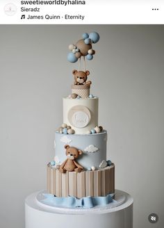 a three tiered cake with teddy bears on top