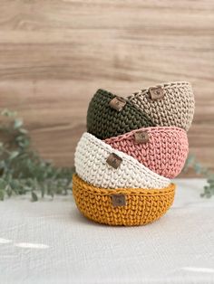 four knitted baskets sitting on top of each other