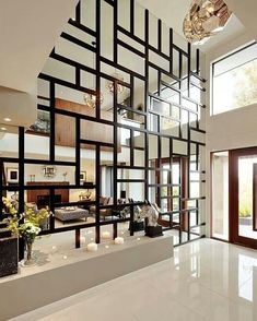 the interior of a modern house with white flooring and black lines on the wall