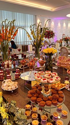 a table filled with lots of desserts and pastries on it's sides