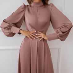 Celebrate your special day in style with our Chic Celebration dress. This stunning satin midi dress in a warm brown hue features elegant long sleeves, making it the perfect choice for a sophisticated birthday celebration. The luxurious satin fabric drapes beautifully, providing a flattering fit that exudes elegance and charm. Whether you're hosting or attending a birthday party, the Chic Celebration dress ensures you stand out with grace and confidence. Embrace the elegant allure of this dress a Long Sleeve Winter Wedding Midi Dress, Winter Wedding Long Sleeve Midi Dress, Long Sleeve Solid Color Midi Dress For Banquet, Long Sleeve Midi Dress For Fall Wedding, Formal Long Sleeve Satin Dress For Fall, Fall Wedding Long Sleeve Midi Dress, Elegant Long Sleeve Satin Dress For Fall, Chic Long Sleeve Midi Dress For Wedding Guest, Formal Long Sleeve Satin Dress