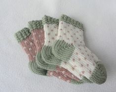 three knitted mittens laying on top of each other