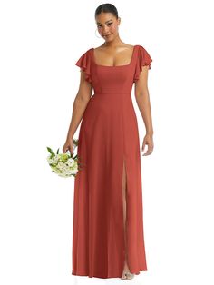 a woman in a long red dress holding a bouquet