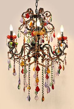 a chandelier with many colorful beads hanging from it's sides and two lights on each side