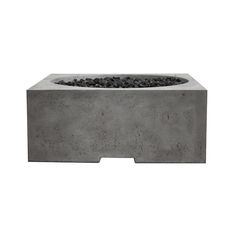 a concrete fire pit with rocks in it