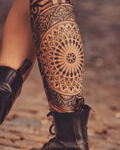 a woman's leg with tattoos on it, and an image of a flower