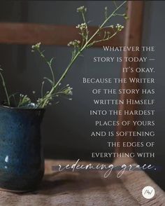 a vase filled with flowers sitting on top of a wooden table next to a quote