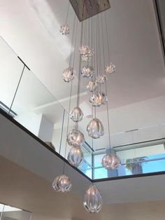 a chandelier hanging from the ceiling in a room with glass balls on it