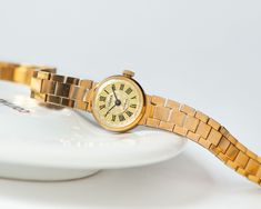 Yellow Gold Analog Watch For Gift, Yellow Gold Watch Gift, Timeless Watch With Gold Clasp As Gift, Vintage Yellow Gold Watches As Gifts, Yellow Gold Watch Accessories With Subdials As Gift, Vintage Yellow Gold Watch Accessories For Gift, Yellow Gold Chronometer Watch As A Gift, Gold Watch Accessories Gift, Cocktail Watch