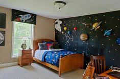 a child's bedroom decorated in space themed decor