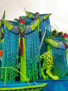 an elaborate float in the shape of a peacock and other animals on top of it