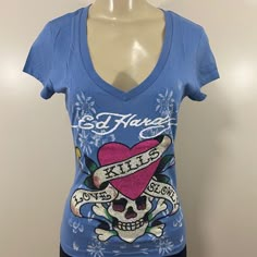 New With Tags Ed Hardy Women Love Kills Slowly Blue Shirt. Has Rhinestone On The Design That Looks Beautiful. V Neck And Short Sleeve Shirt. Multiple Sizes Available. 2000s Fashion Shirts, Trendy Blue V-neck Shirt, Blue Cotton V-neck Shirt, Mcbling Shirts, Ed Hardy Shirt, Ed Hardy Outfit, Vintage Dior Dress, 00s Mode, 2000s Clothing