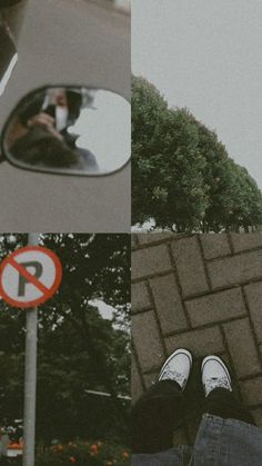 a person's reflection in the side view mirror of a car and a no parking sign