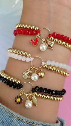 several different bracelets with charms on them