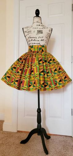 "*START CONVERSATION for ordering OPTIONS*PLEASE READ FULL DESCRIPTIONCute African Kente print cotton skirt High waist and gathering all around.  Available in any size. Less than 22 inch to 51 inch or more. (THIS IS YOUR ACTUAL WAIST IN INCHES) Approximately 20 inches long. Feel free to REQUEST CUSTOMIZE SKIRT and send your actual waist and length requirements in inches.  OR Select the size range based on your actual waist measurement in inches. Un-Lined - (Very thick fabric. If you feel you need lining to be attached feel free to contact me or indicate in your order for pricing) Two good size side pockets This garment contains a flat front and elastic in the back for a comfortable fit. All colors available as well as varying prints based on background color (colors may vary due to availab Multicolor Cotton Mini Skirt, Retro Cotton Mini Skirt, Multicolor Cotton Tiered Mini Skirt, Multicolor Tiered Cotton Mini Skirt, Green Full Cotton Skirt, Multicolor Gathered Full Skirt, Multicolor Full Gathered Skirt, Green Retro Cotton Mini Skirt, Multicolor Cotton Knee-length Skirt