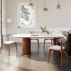 a dining room table with four chairs and a vase on the table next to it