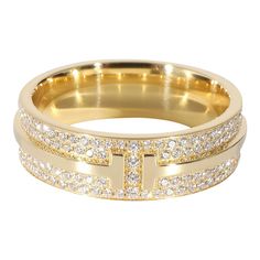 This is part of Chairish’s Fine Jewelry assortment.  Tiffany & Co. Tiffany T Ring in 18K Yellow Gold 0.61 CTW  PRIMARY DETAILS  SKU: 134213  Listing Title: Tiffany & Co. Tiffany T Ring in 18K Yellow Gold 0.61 CTW  Condition Description: Inspired by the 'T' motif that Tiffany has been incorporating since the '80s, the T collection is both striking and classic at once.     Retails for 9600 USD. In excellent condition and recently polished. Ring size is 7. Comes with Box;  Brand: Tiffany & Co.  Col Tiffany T Ring, T Ring, Tiffany Ring, Tiffany Rings, Push Presents, Tiffany T, Vintage Tiffany, Luxe Jewelry, Modern Ring