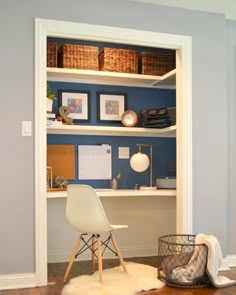 a room with a chair, desk and bookshelf in it's corner