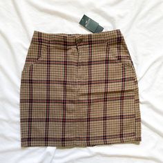 Peep This Adorable Hollister Plaid Mini Skirt! This Lightweight And Snug Little Beauty Boasts The Perfect School Girl Clueless Vibes. Well Suited For Those With A Love Of Dark Academia As Well As Those With A More Preppy Aesthetic. Classic Plaid In Tan, Black, And Red. Front Pockets. Ultra High Rise. Lightweight. Brand Name: Hollister Market: Women’s, Skirts, Mini Skirt, Short Skirt Size: Xs Color: Tan, Black, Red Retail Price: $39.95 Material: 96% Cotton, 4% Spandex Measurements: 12.5” Rise, 16 Mini Skirt Plaid, Clueless Vibes, High Rise Denim Skirt, White Jean Skirt, Hollister Skirt, Button Down Mini Skirt, Tiered Mini Skirt, Green Mini Skirt, High Rise Skirt